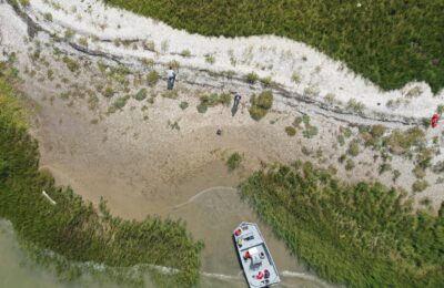 Giraffe Head drone photo from above with a shoreline and boat